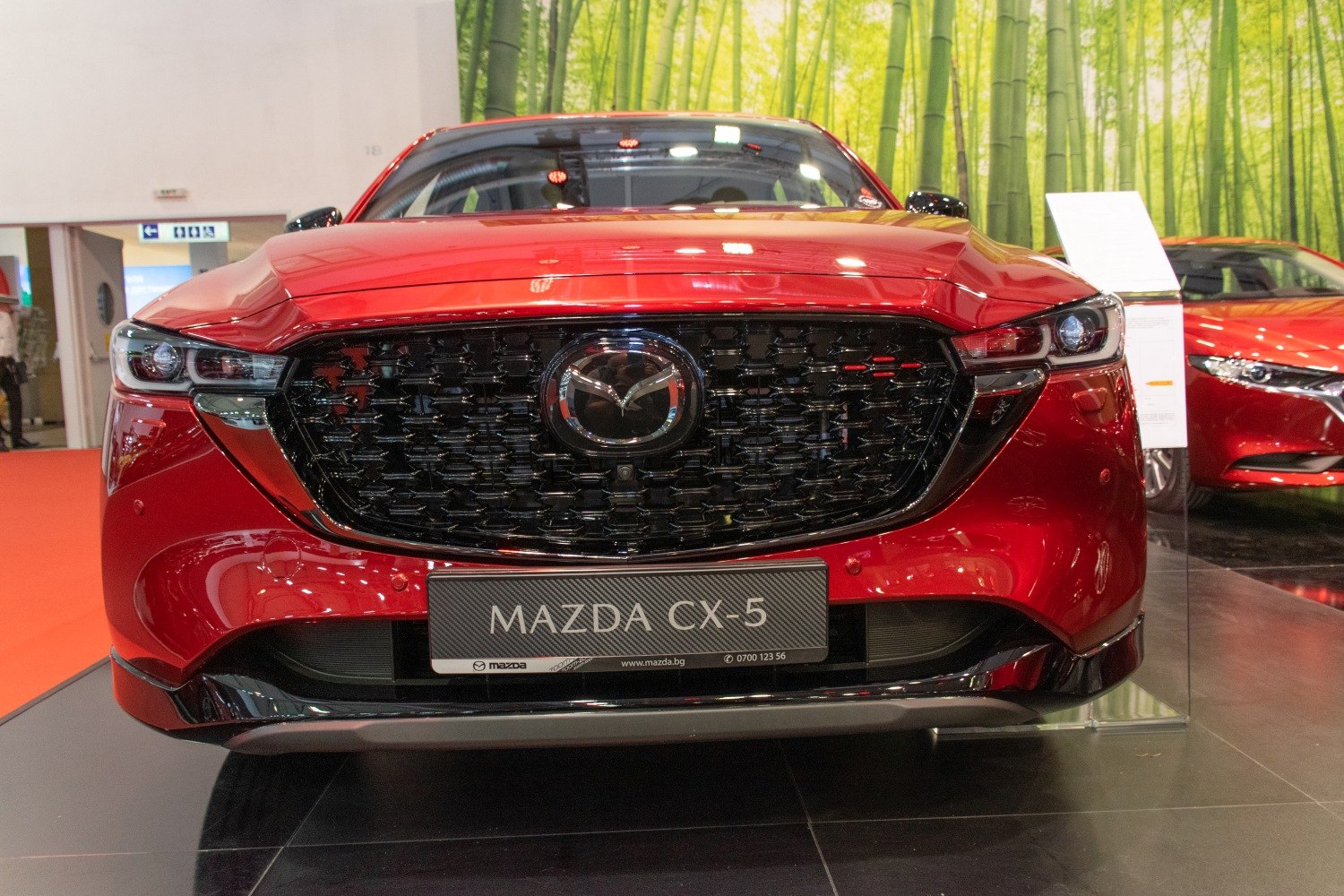 Close-up of Mazda CX-5 II facelift front grille and headlights.