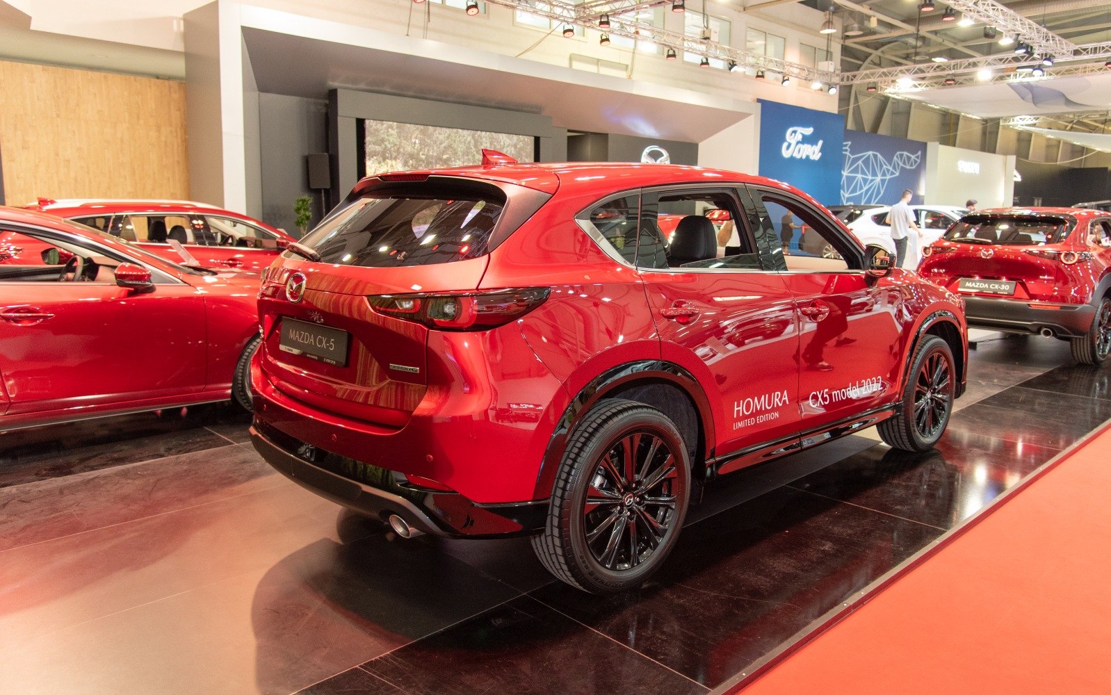 Rear and side view of red SUV with black alloy wheels and modern taillights