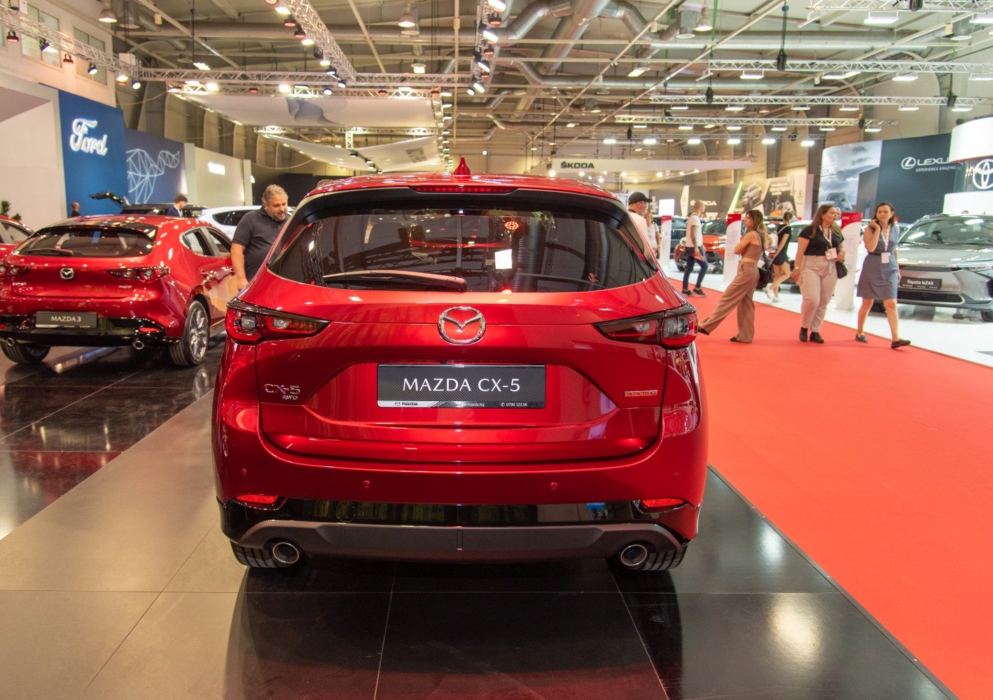Red SUV rear with distinct tail lights and dual exhaust pipes