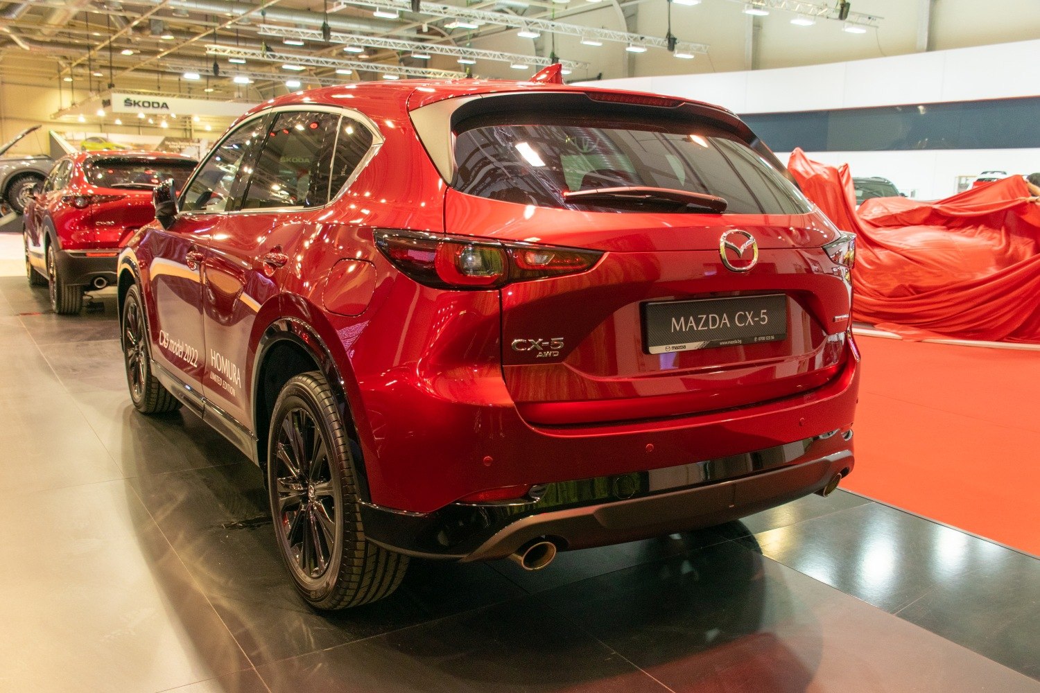 Rear view of red SUV with black alloy wheels and dual exhaust pipes