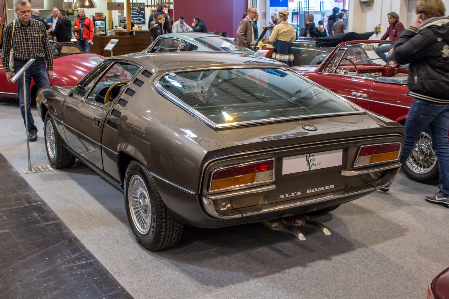Rear louvered fastback coupe with sporty dual exhaust and classic wheel design