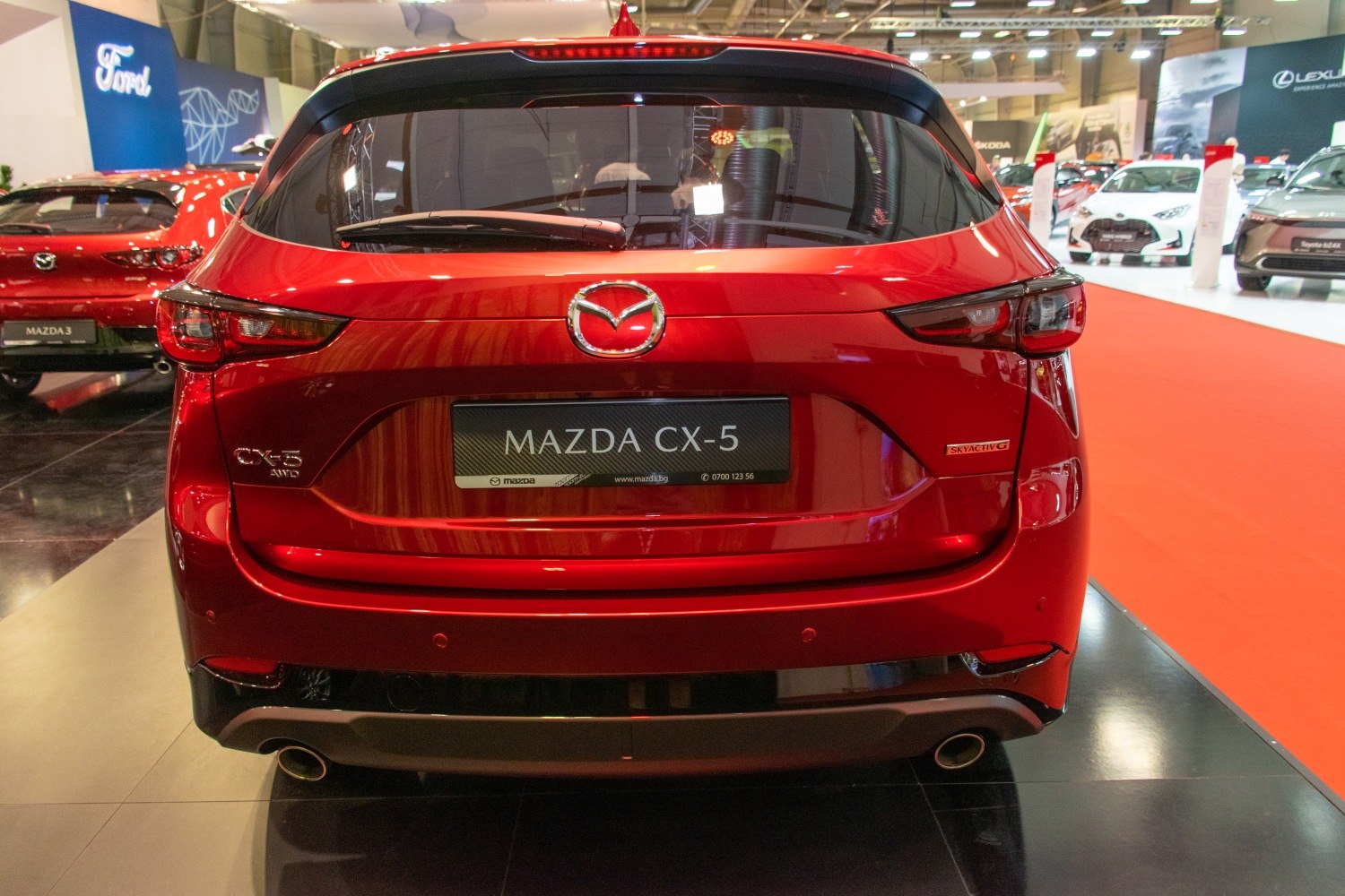 Rear view of a red SUV with LED taillights and dual exhausts