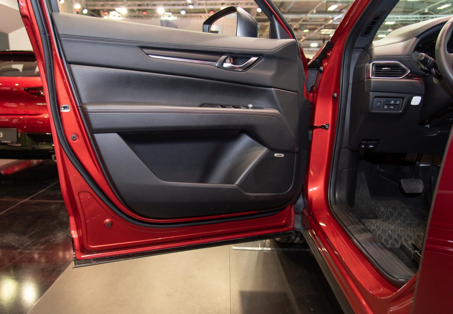 Interior door panel with integrated Bose speaker and control buttons