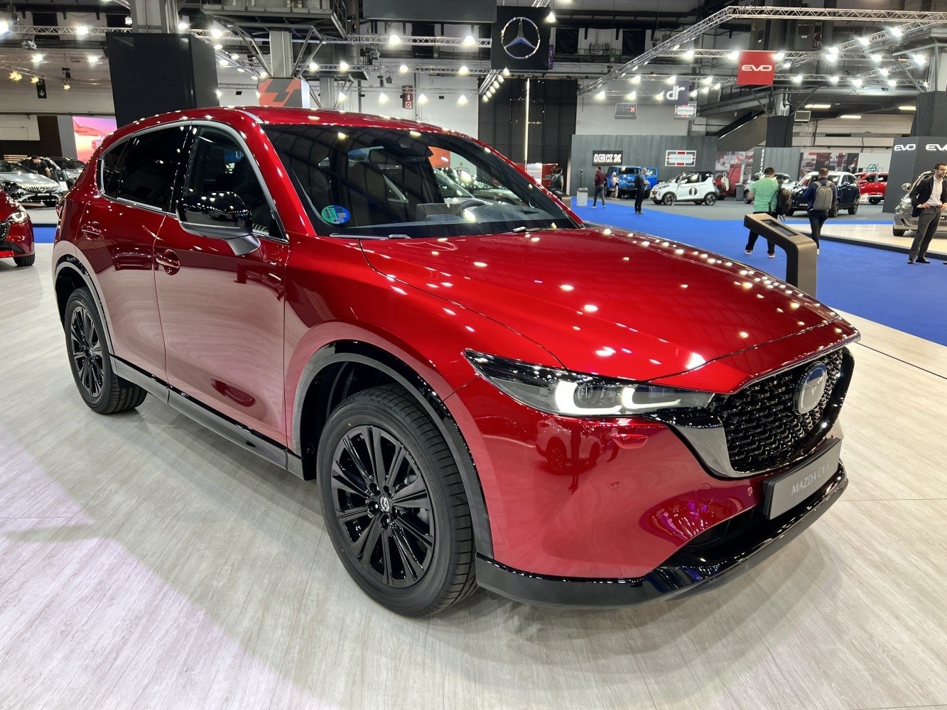 Front left view with LED headlights and bold front grille in red finish