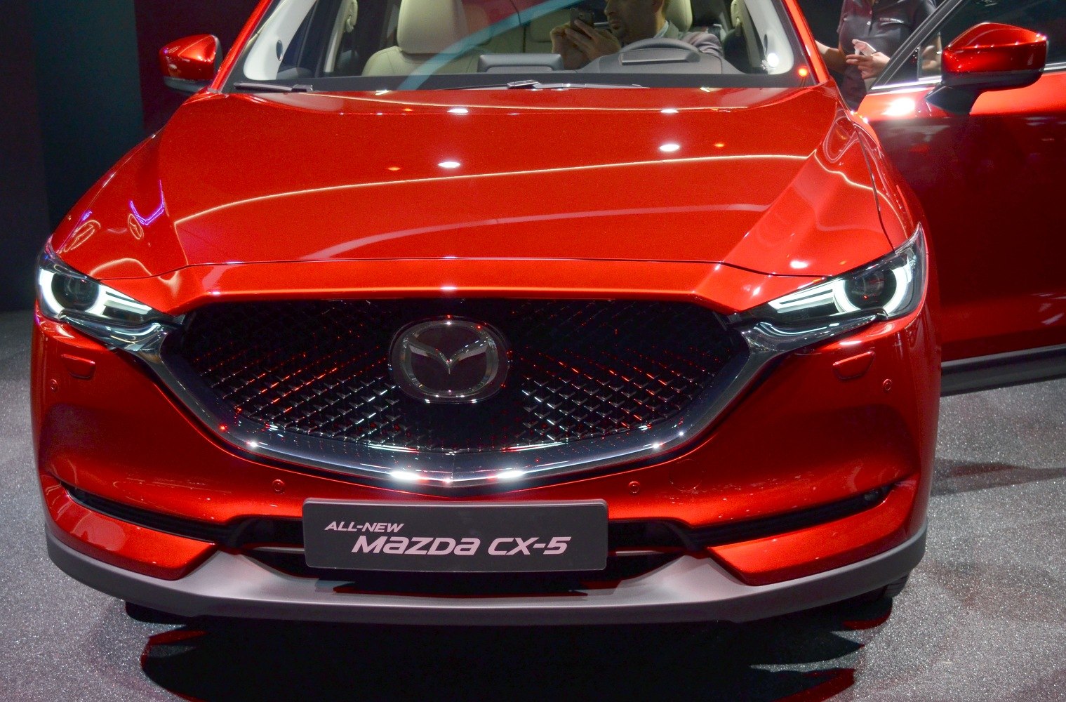 Close-up of front grille with Mazda emblem and LED headlights