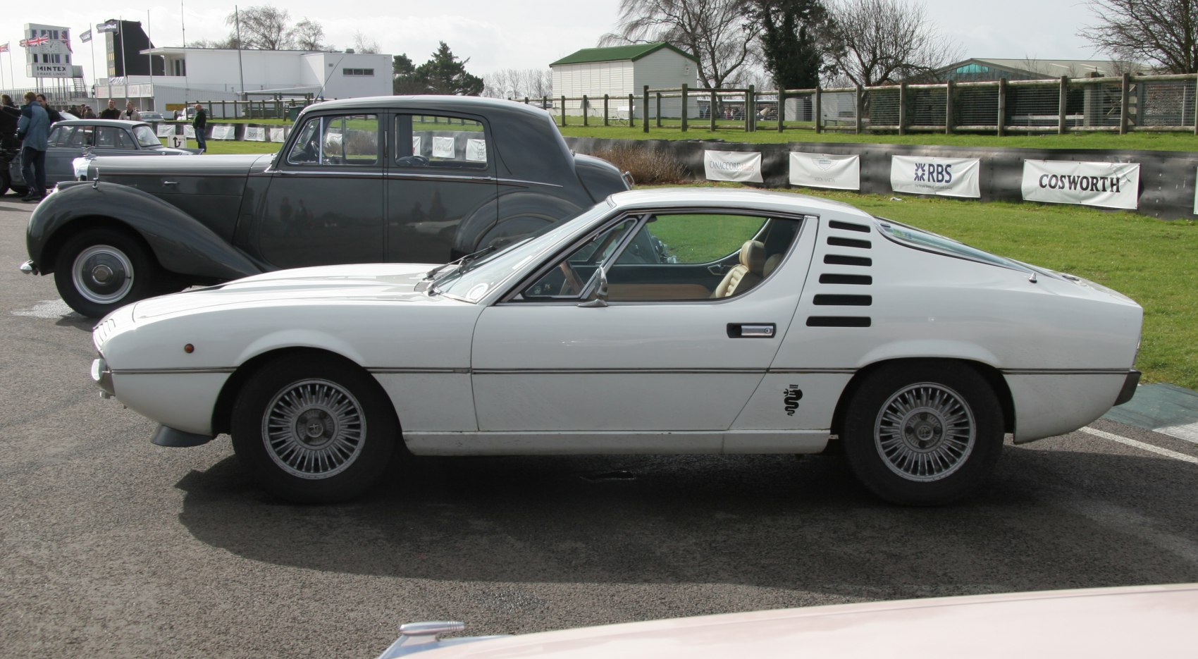 White classic sports coupe with side louvers and alloy wheels