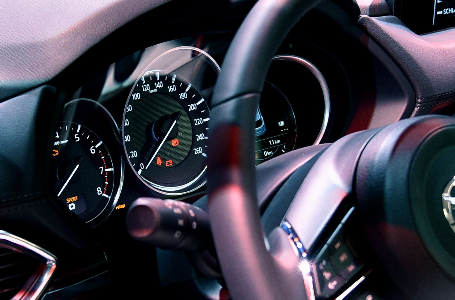 Car dashboard with speedometer and tachometer close-up