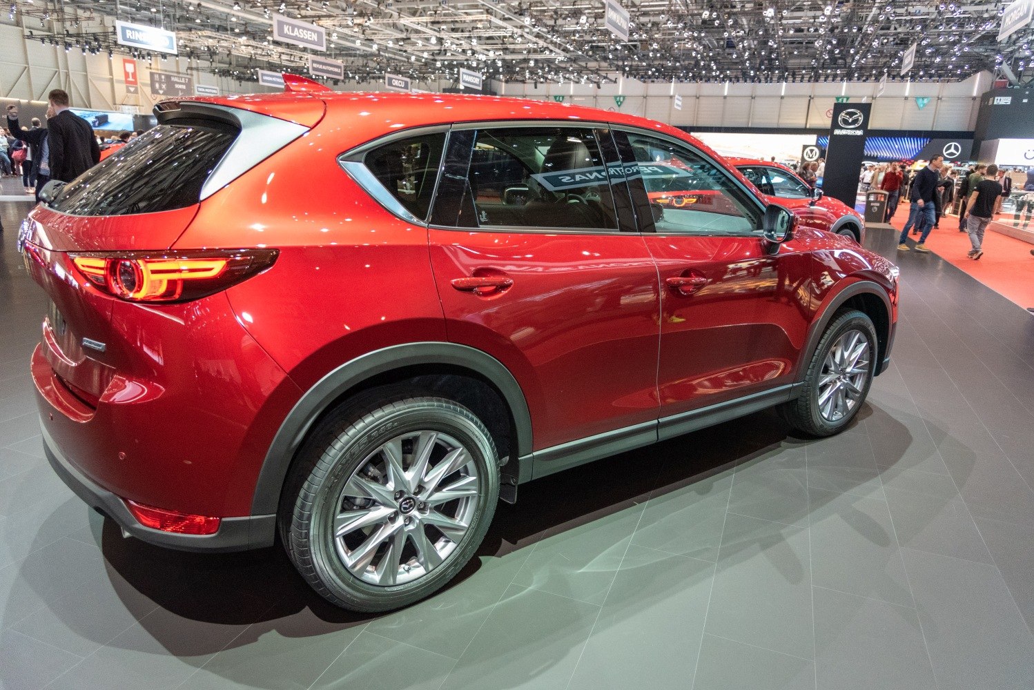 Red SUV rear side view with modern taillights and alloy wheels