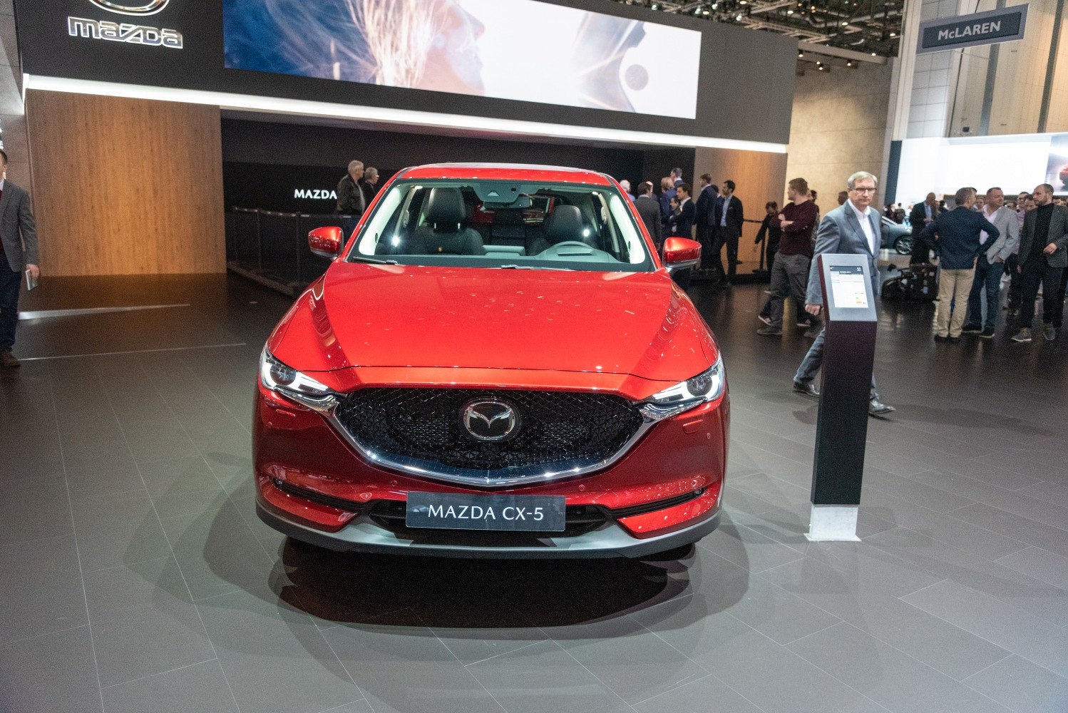 Front view of red SUV with Mazda grille and headlights