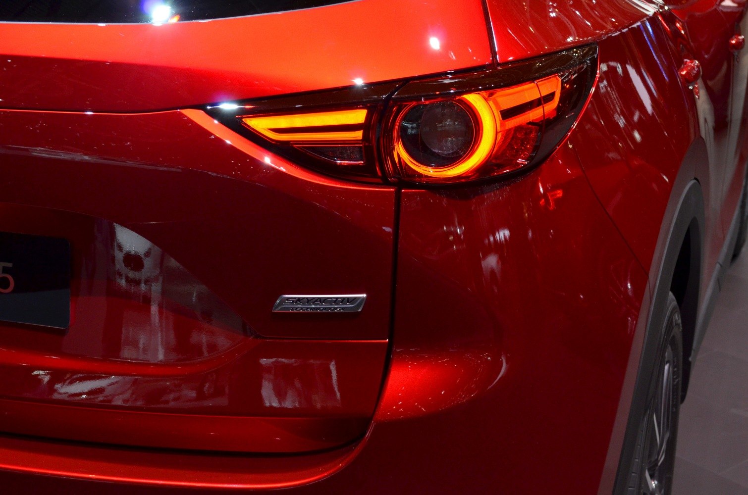 Rear LED taillight and Skyactiv badge on red SUV