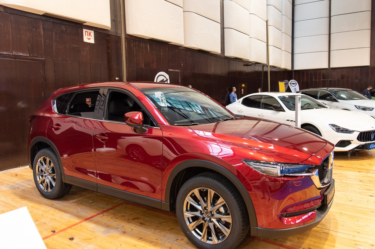 Side profile and front design of red SUV with alloy wheels