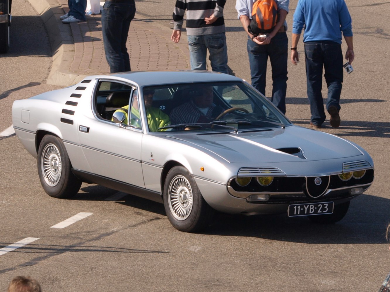 Silver coupe with quad yellow headlights and vented rear pillars