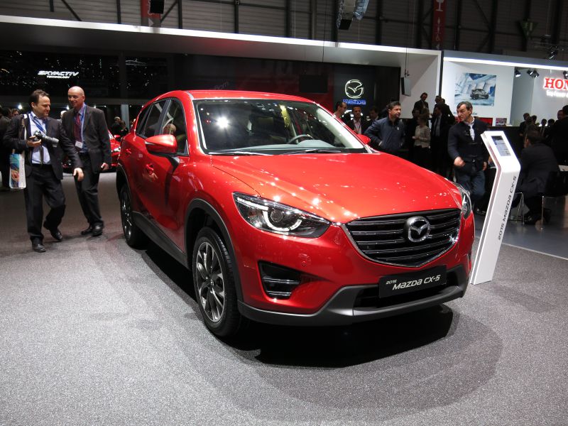Red SUV front view with updated grille and modern headlights
