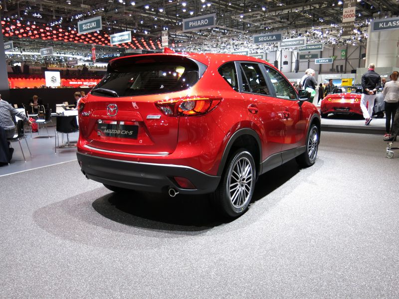 Rear and side view of red SUV with modern taillights and alloy wheels