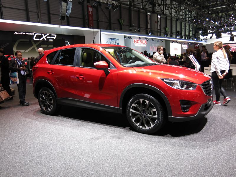 Red compact SUV with alloy wheels and sharp headlights