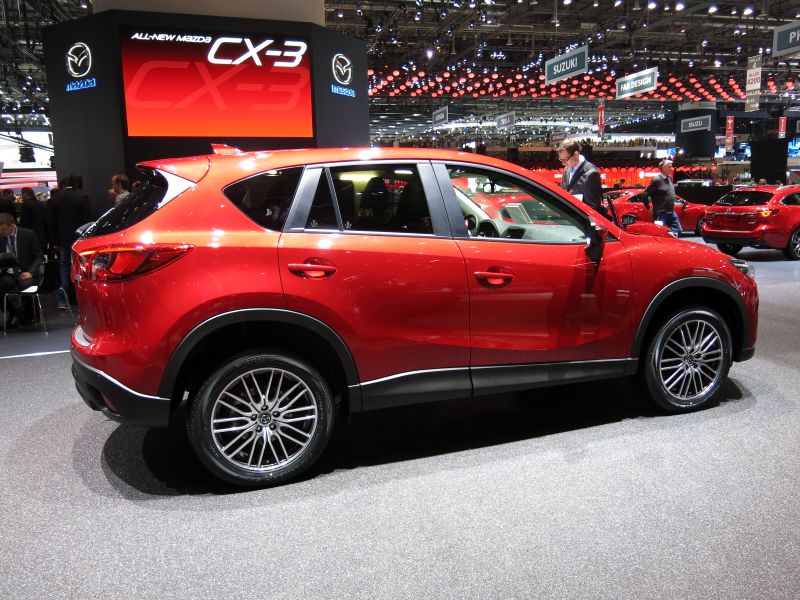 Red SUV side profile with alloy wheels and modern design