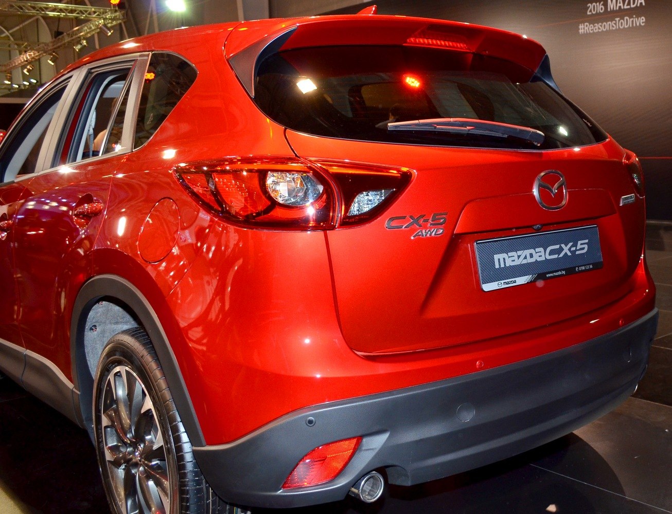 Red SUV rear with distinctive taillights and AWD badge