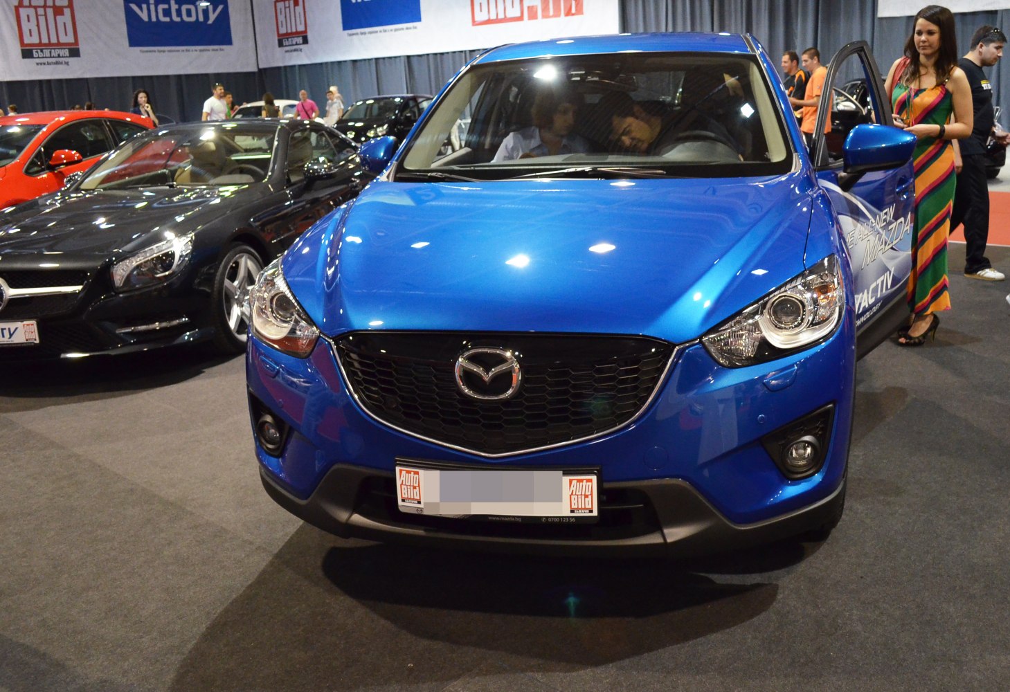 Front close-up of blue Mazda CX-5 with grille and headlights