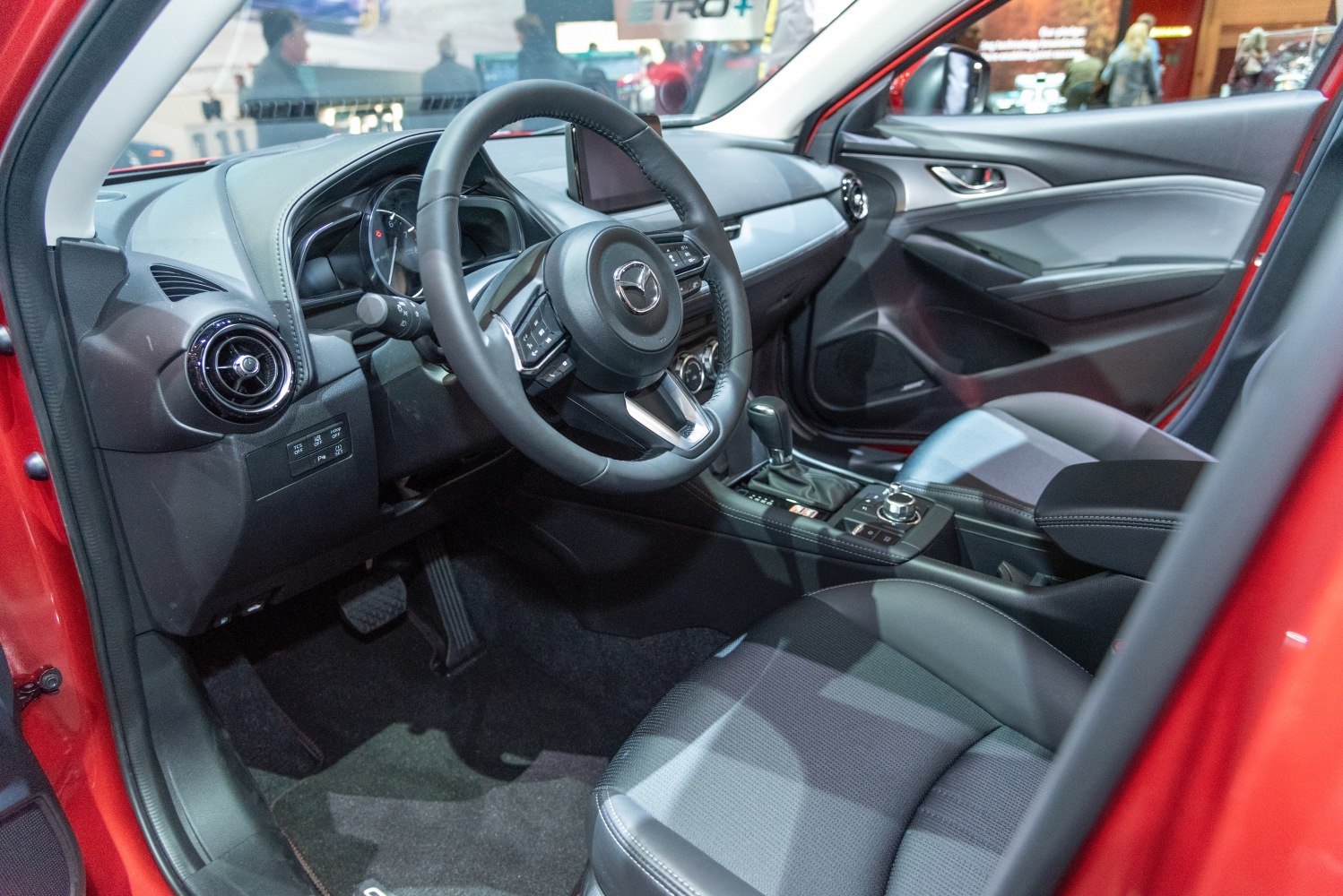 Car interior with steering wheel, dashboard, and center console