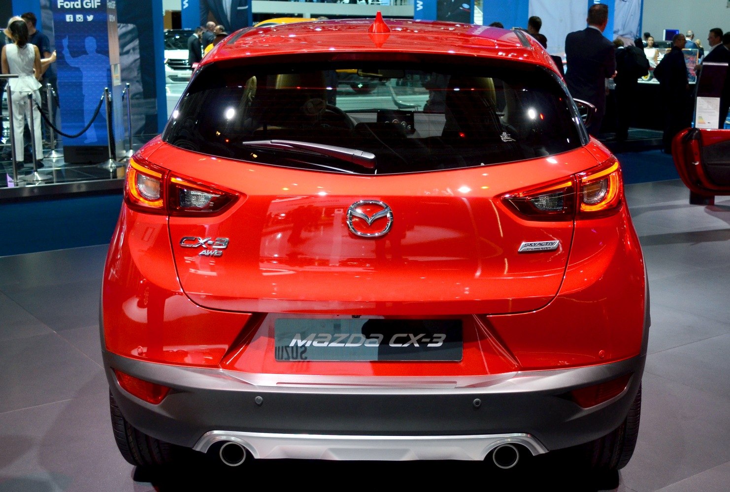 Rear view with dual exhaust pipes and illuminated tail lights