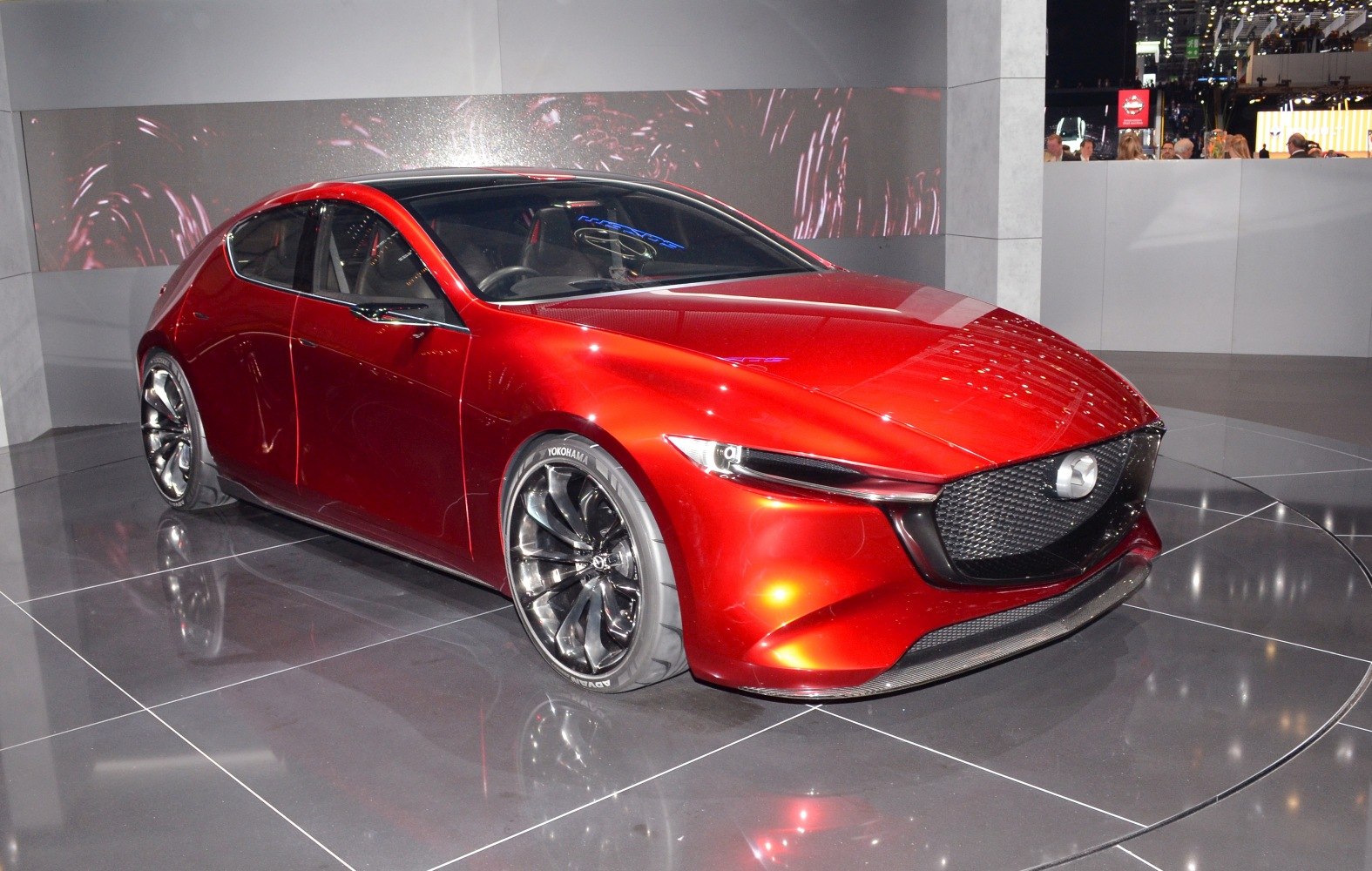 Sleek red hatchback with LED headlights and mesh grille