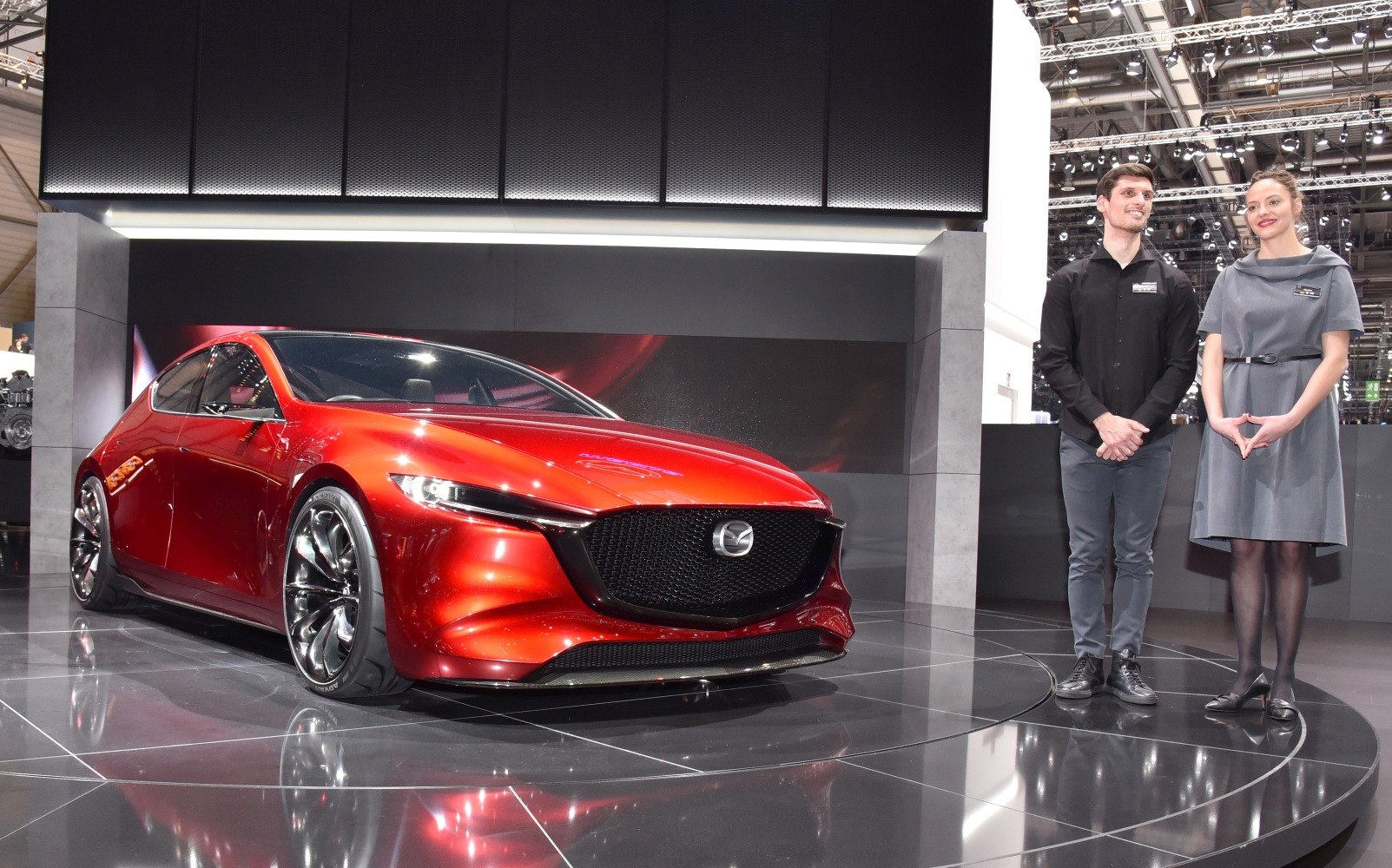 Red car with large black grille and sleek aerodynamic shape