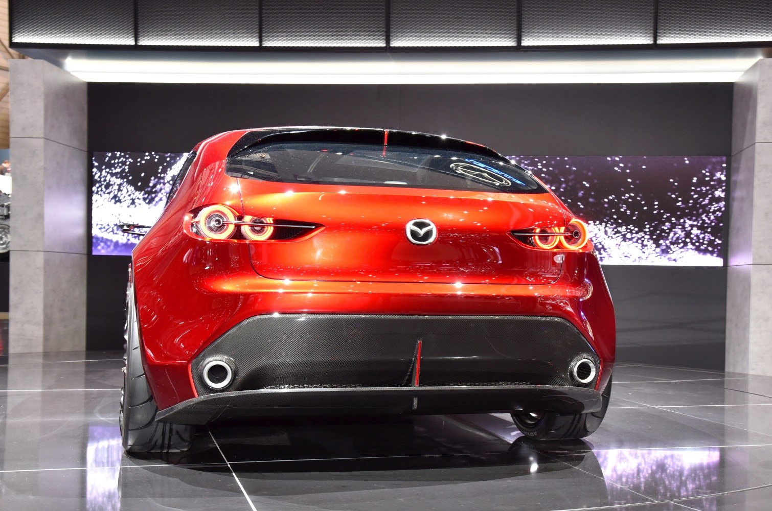 Red hatchback rear with distinctive circular LED taillights and dual exhausts
