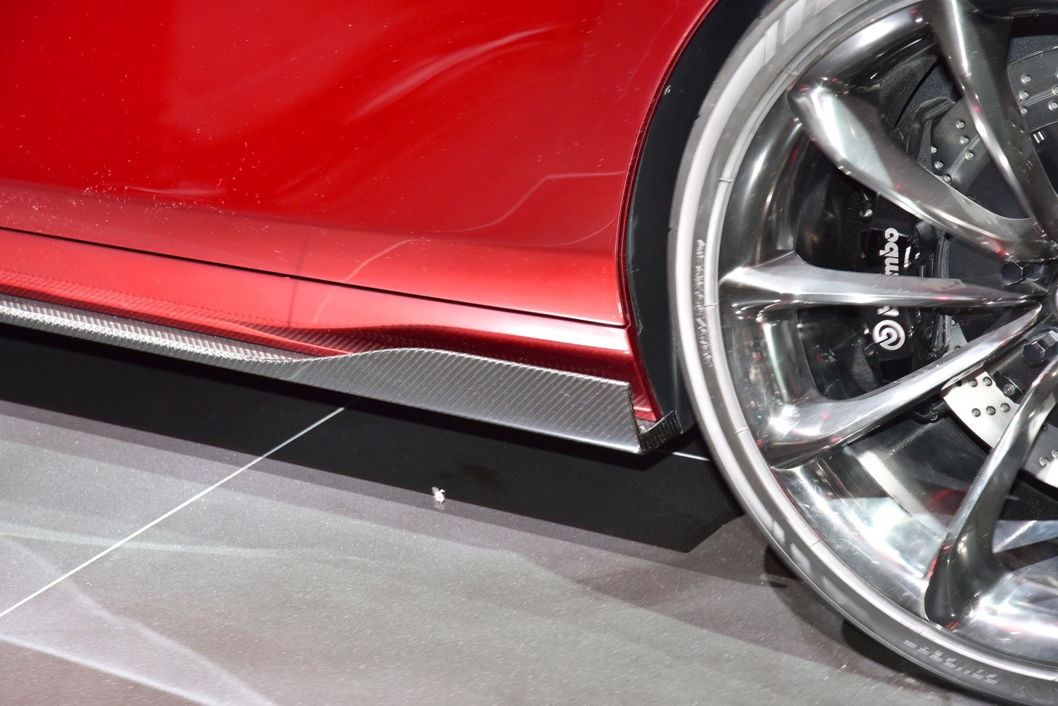 Polished alloy wheel with Brembo brakes and carbon fiber side skirt