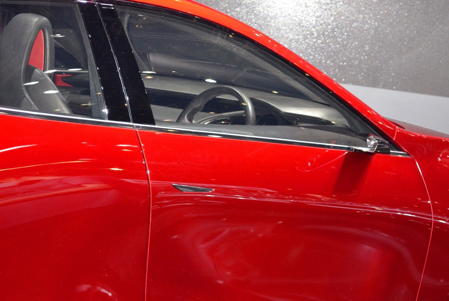 Side door with window and visible interior steering wheel
