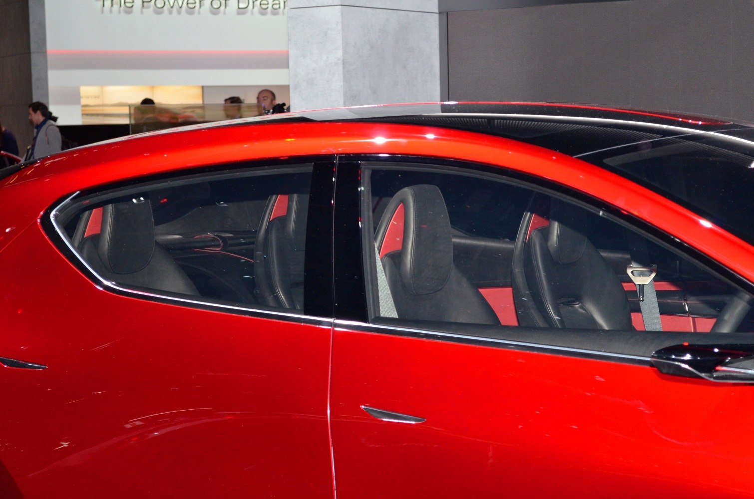 Red car side with sporty black seats visible through windows