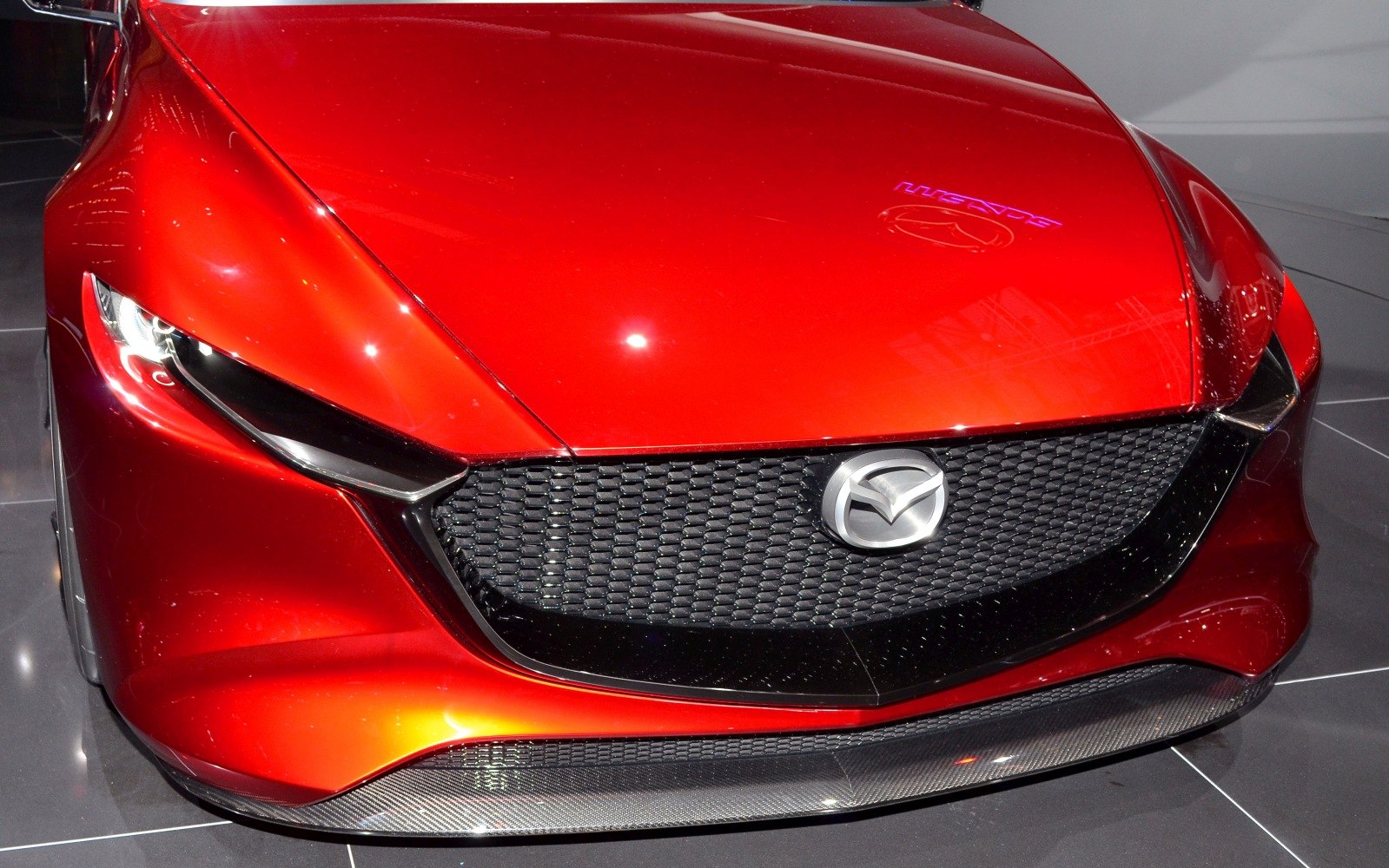 Close-up of a sculpted front grille and sharp LED headlights