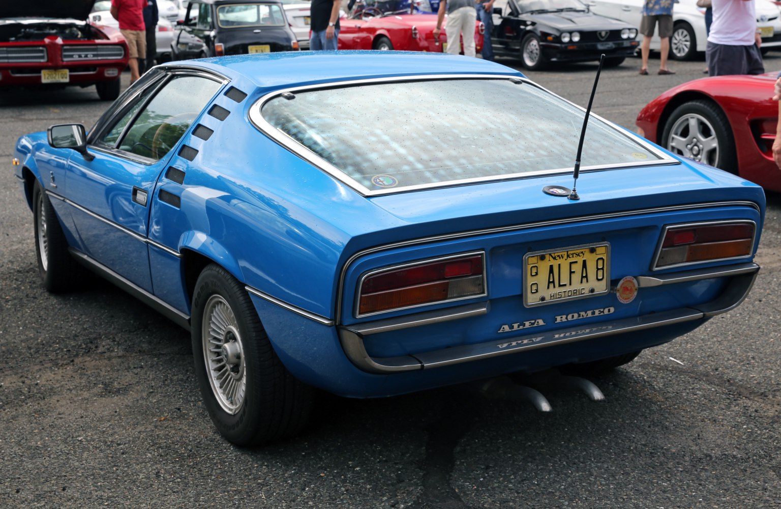 1970s sports coupe rear with louvered side vents and large rear window