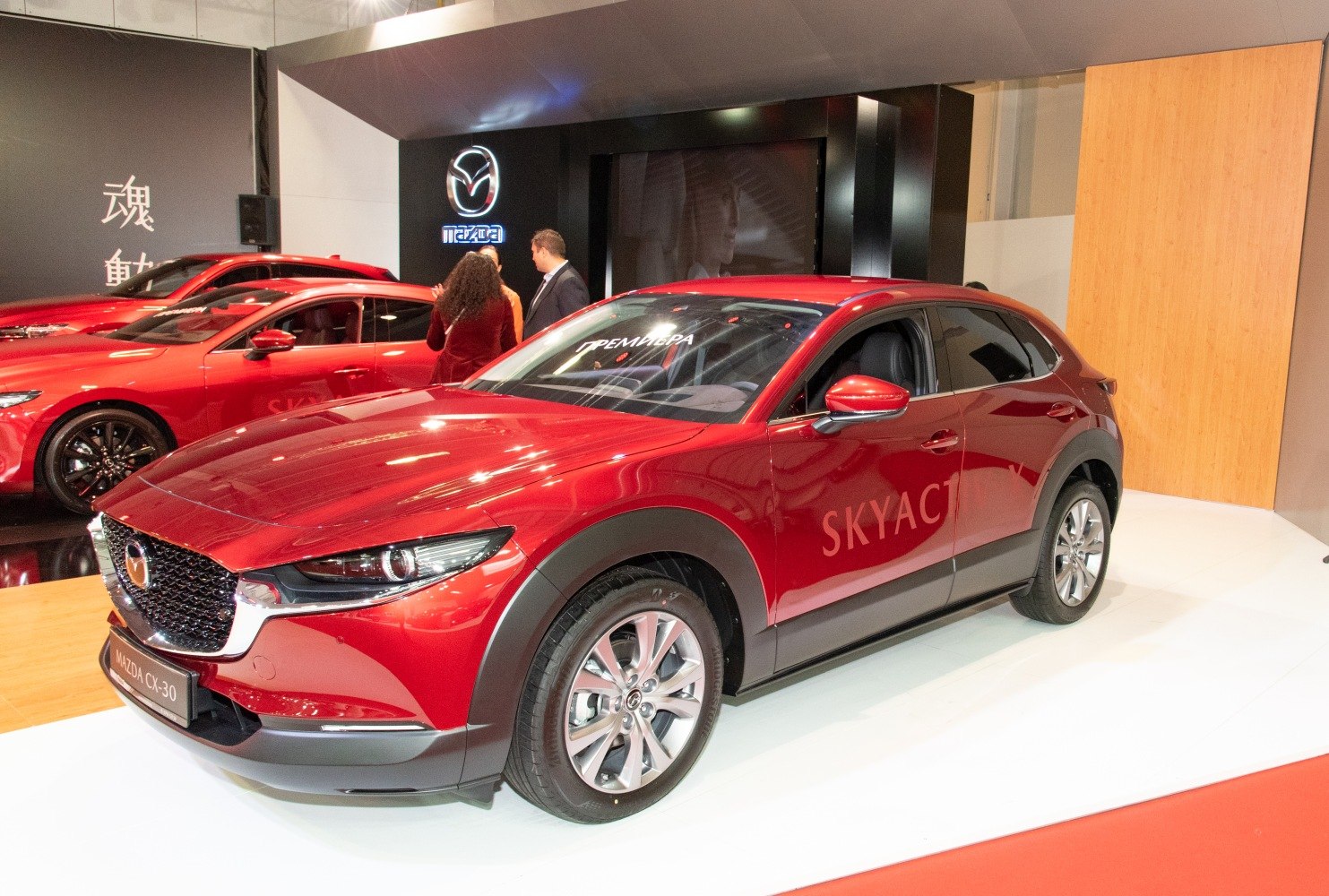 Red SUV with prominent headlights and bold black wheel arches