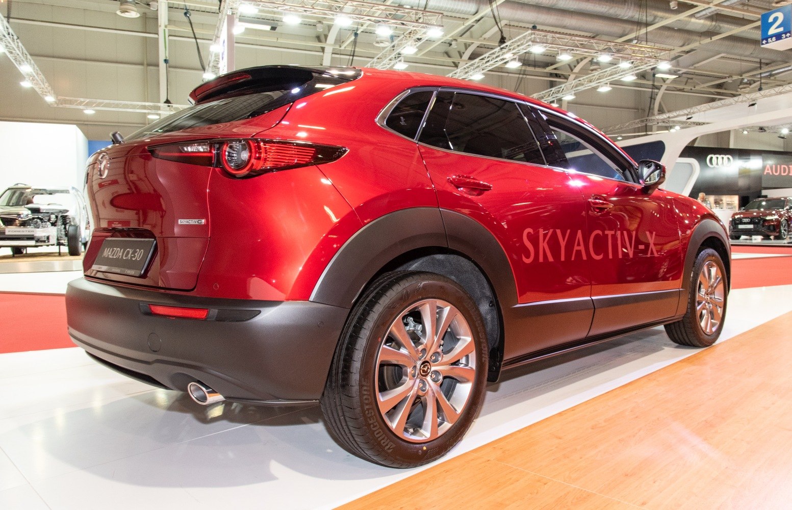 Red SUV rear and side view with Skyactiv-X badge and alloy wheels
