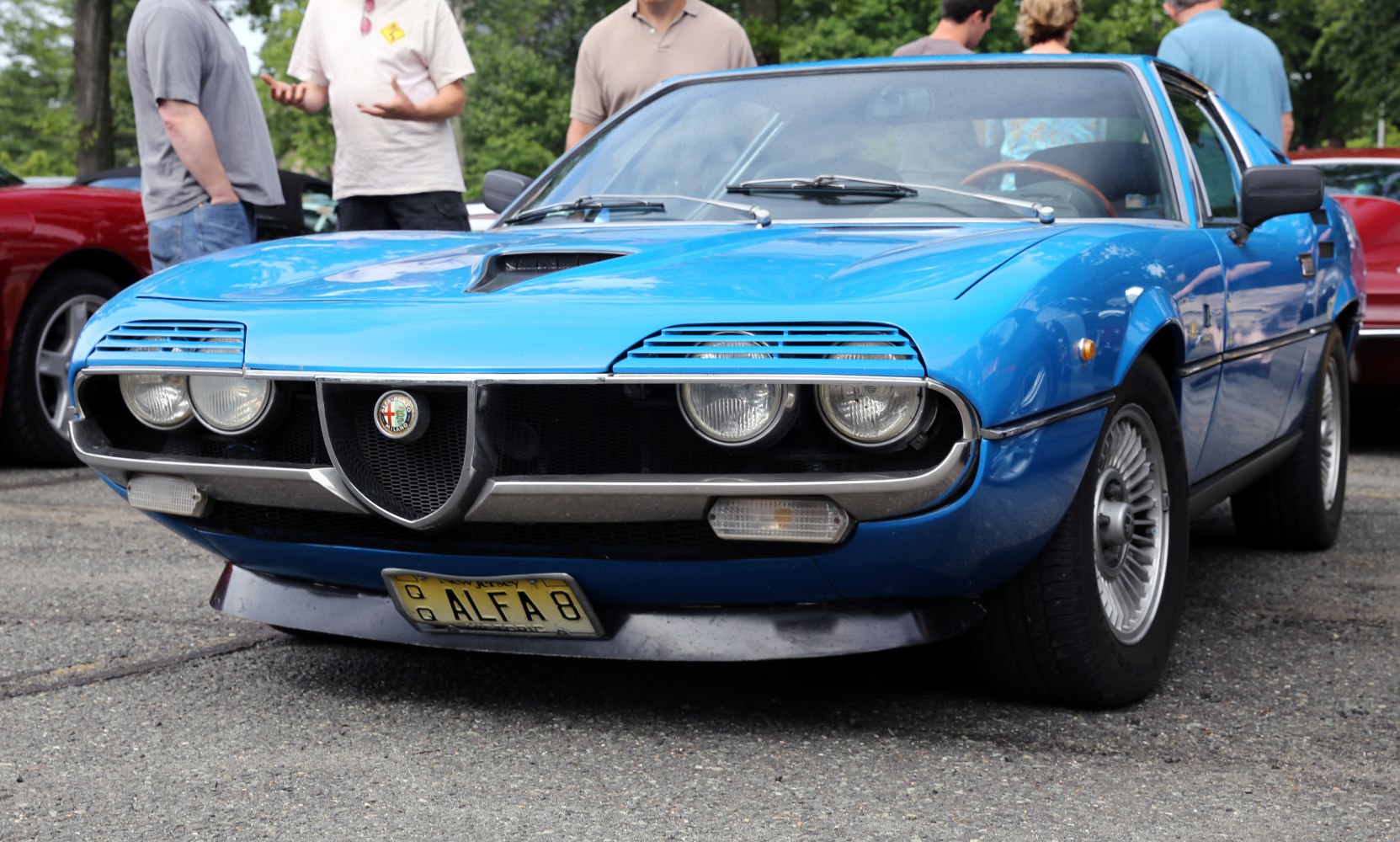 Front view of blue vintage sports coupe with distinctive headlights and grille