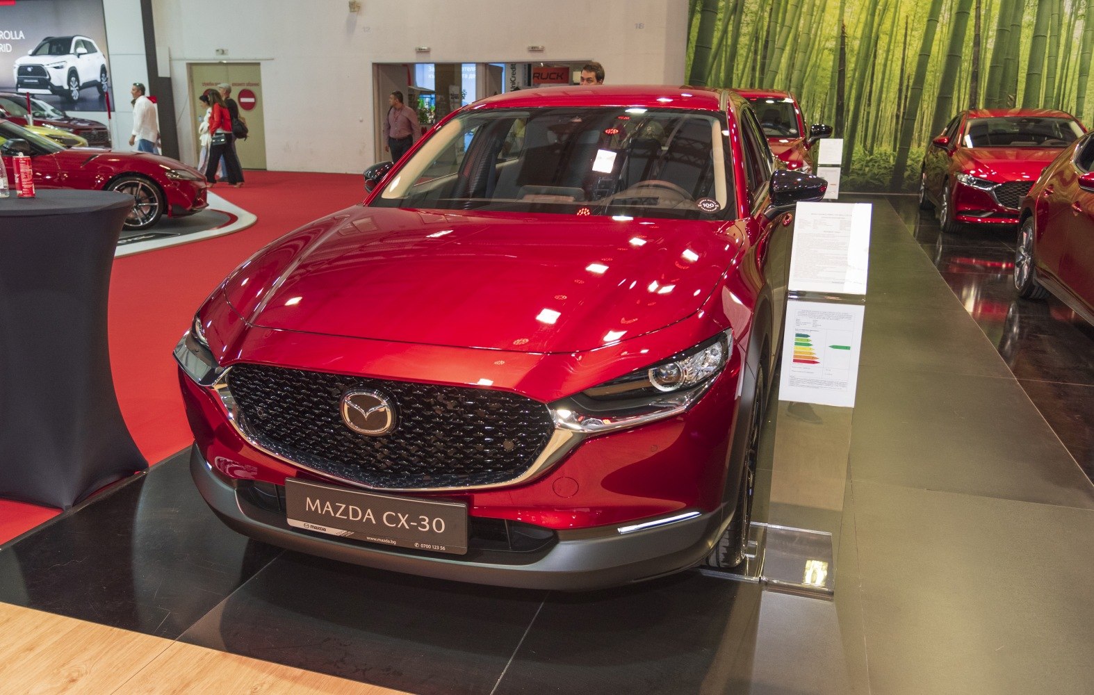 Red Mazda CX-30 front with large grille and sharp headlights