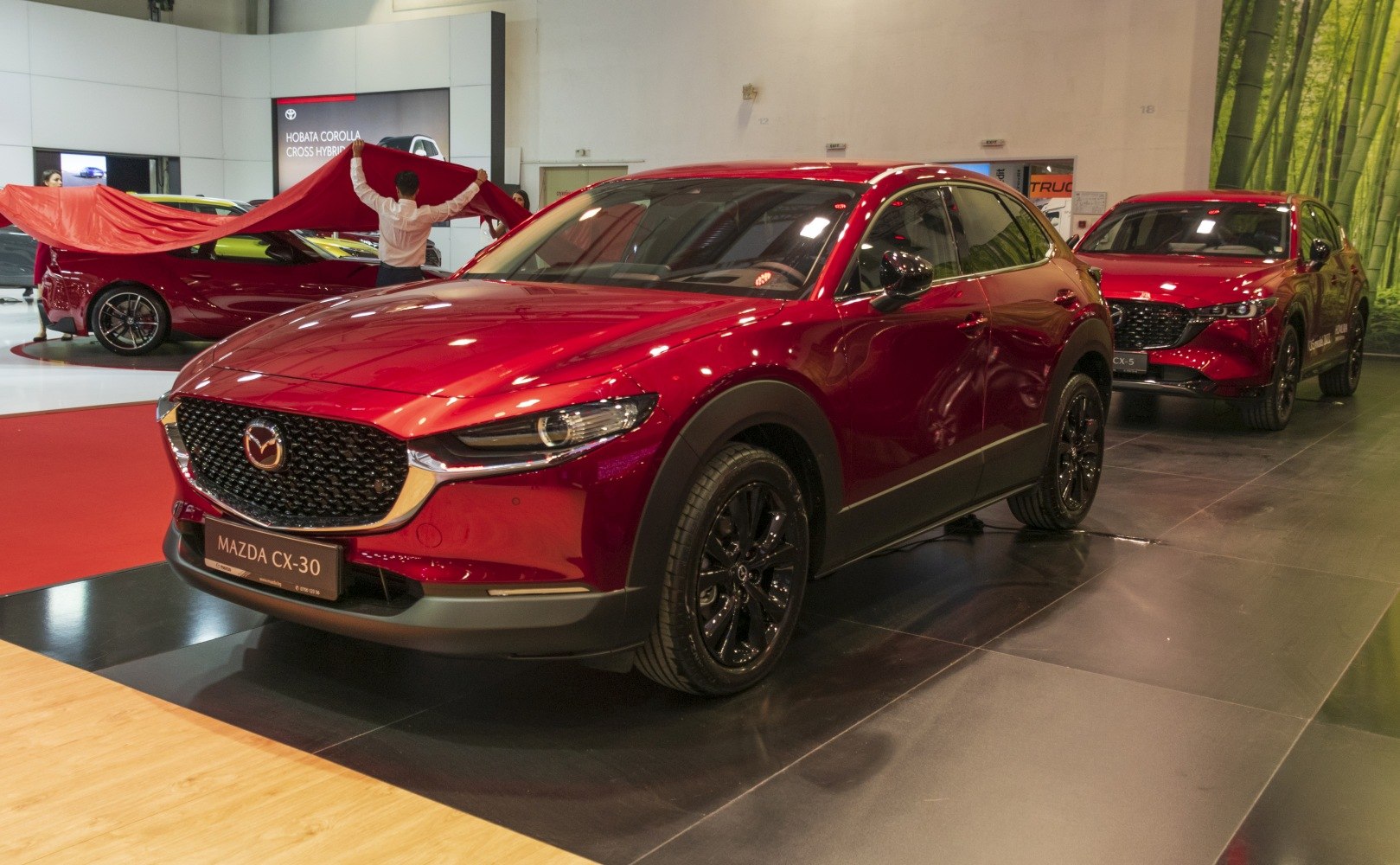 Red compact crossover SUV with black wheels and sleek front design