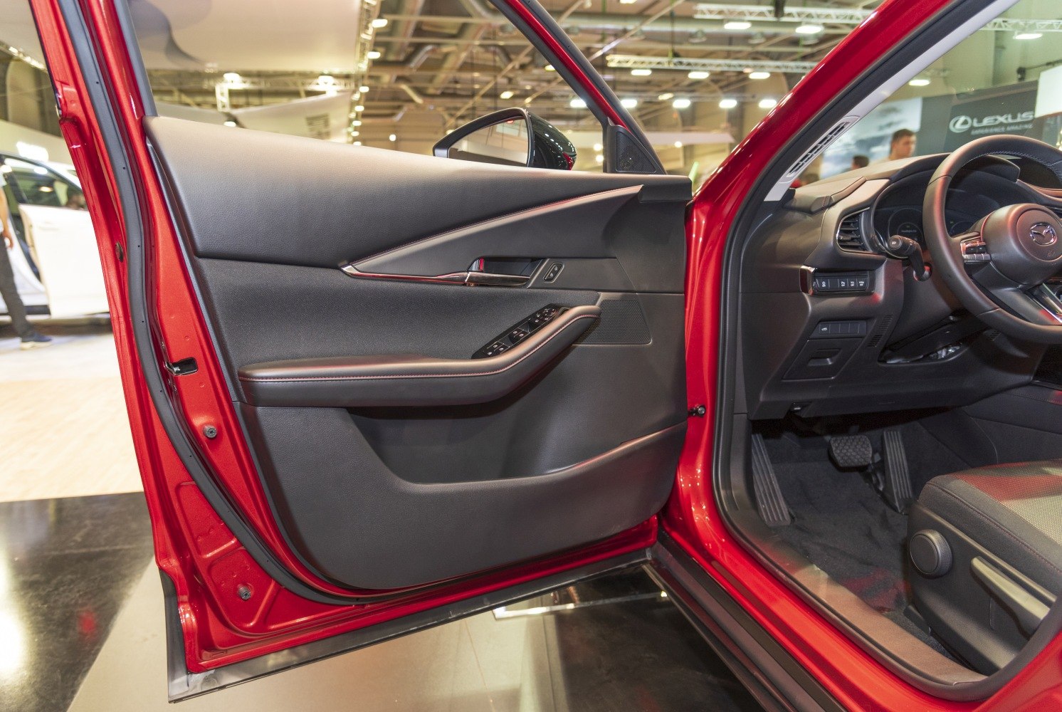 Interior driver door panel with control buttons and armrest