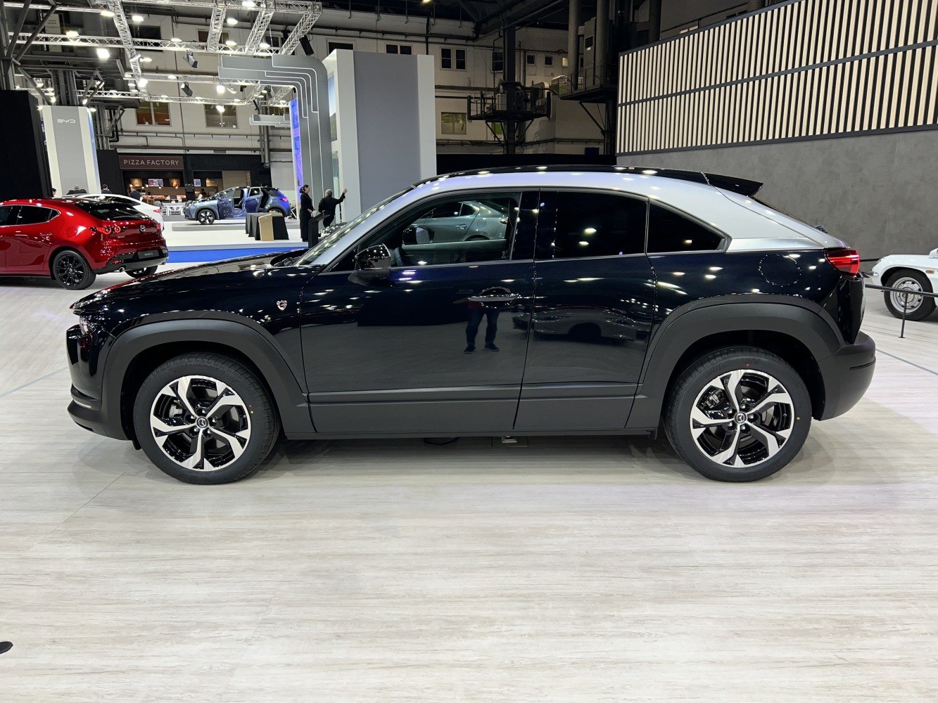 Side profile of a black SUV with alloy wheels