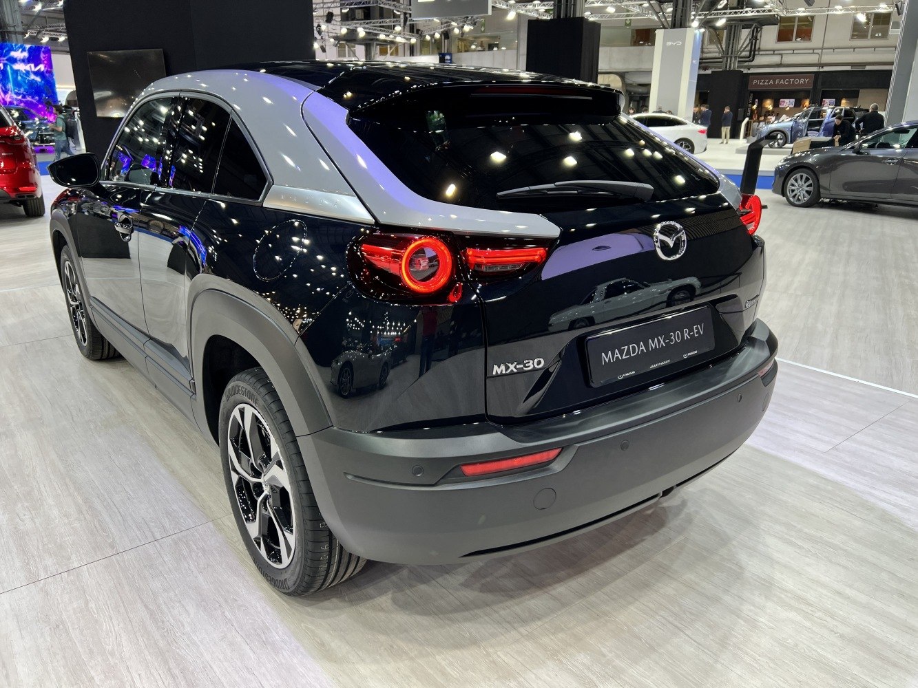 Rear view with circular LED tail lights and sleek black and grey design