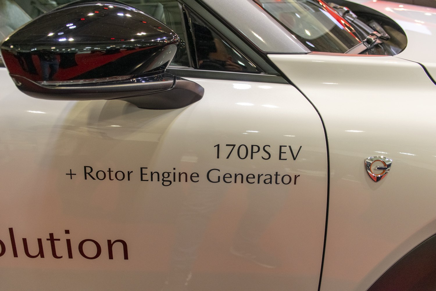 Close-up of EV power badge and rotor engine generator text on car side panel