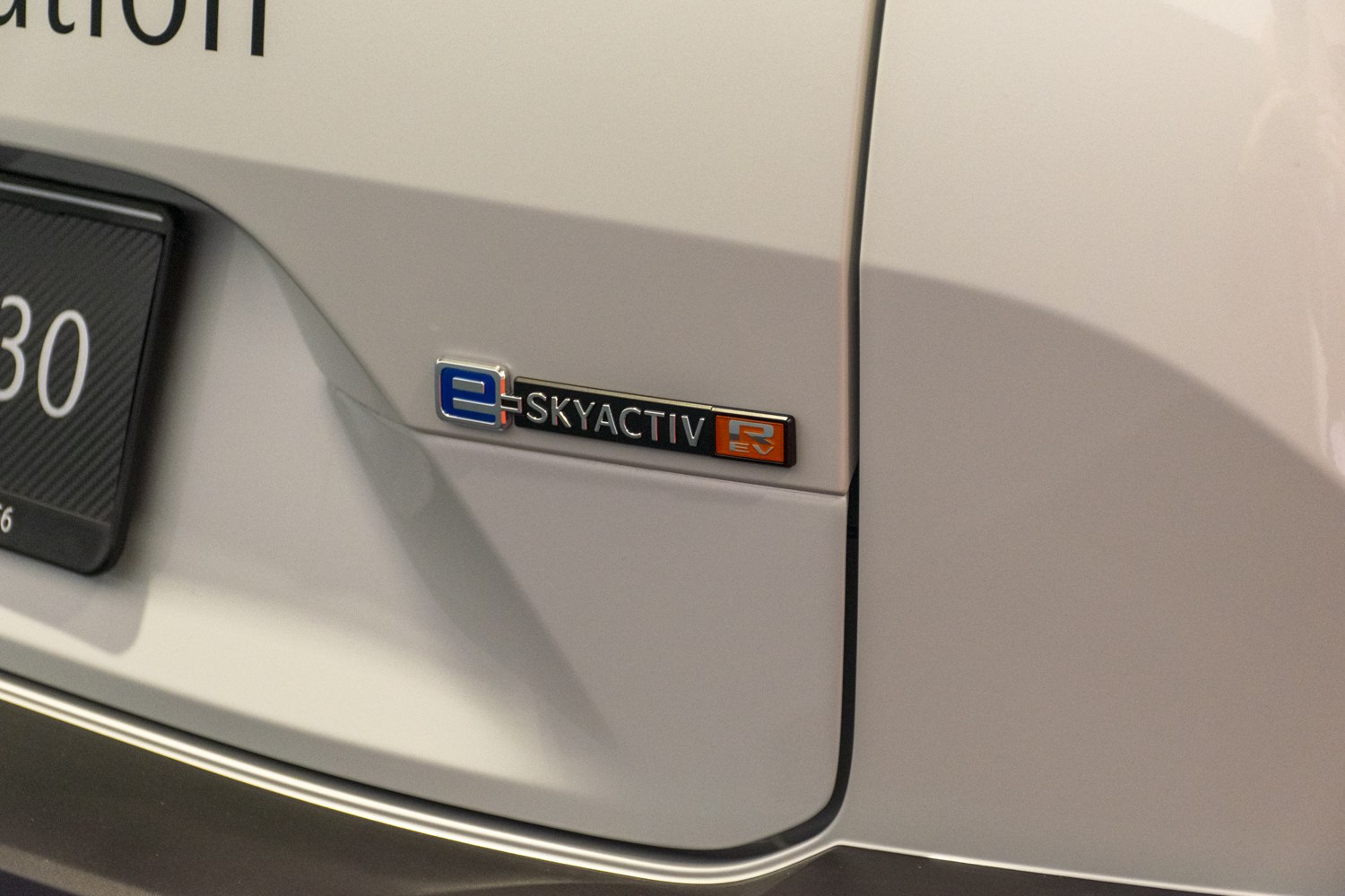 Close-up of Mazda MX-30 e-Skyactiv EV emblem on rear side panel