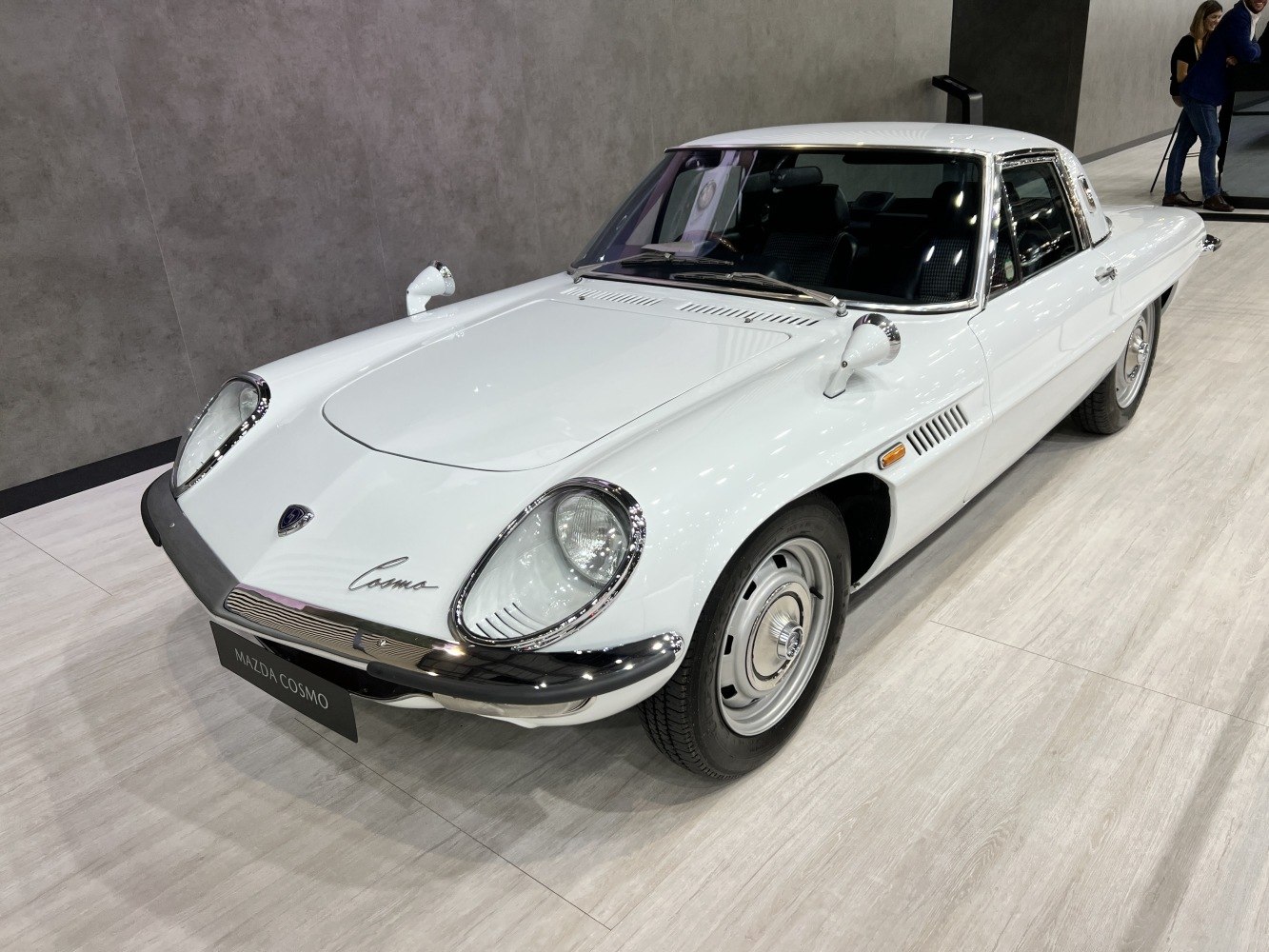 Front side view with distinctive oval headlights and classic coupe styling