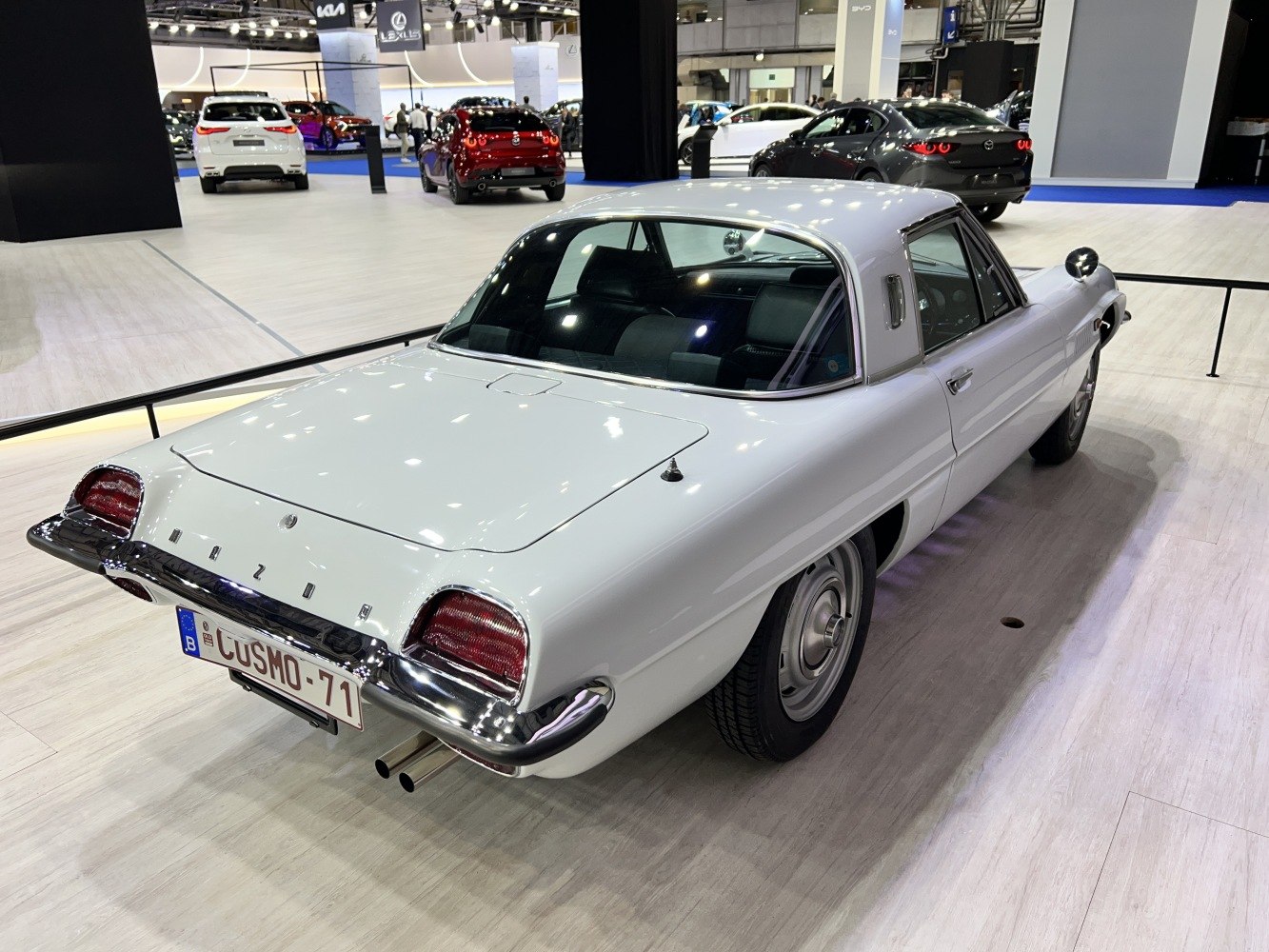 Rear three-quarter view of a vintage coupe featuring chrome bumper and distinctive tail lights