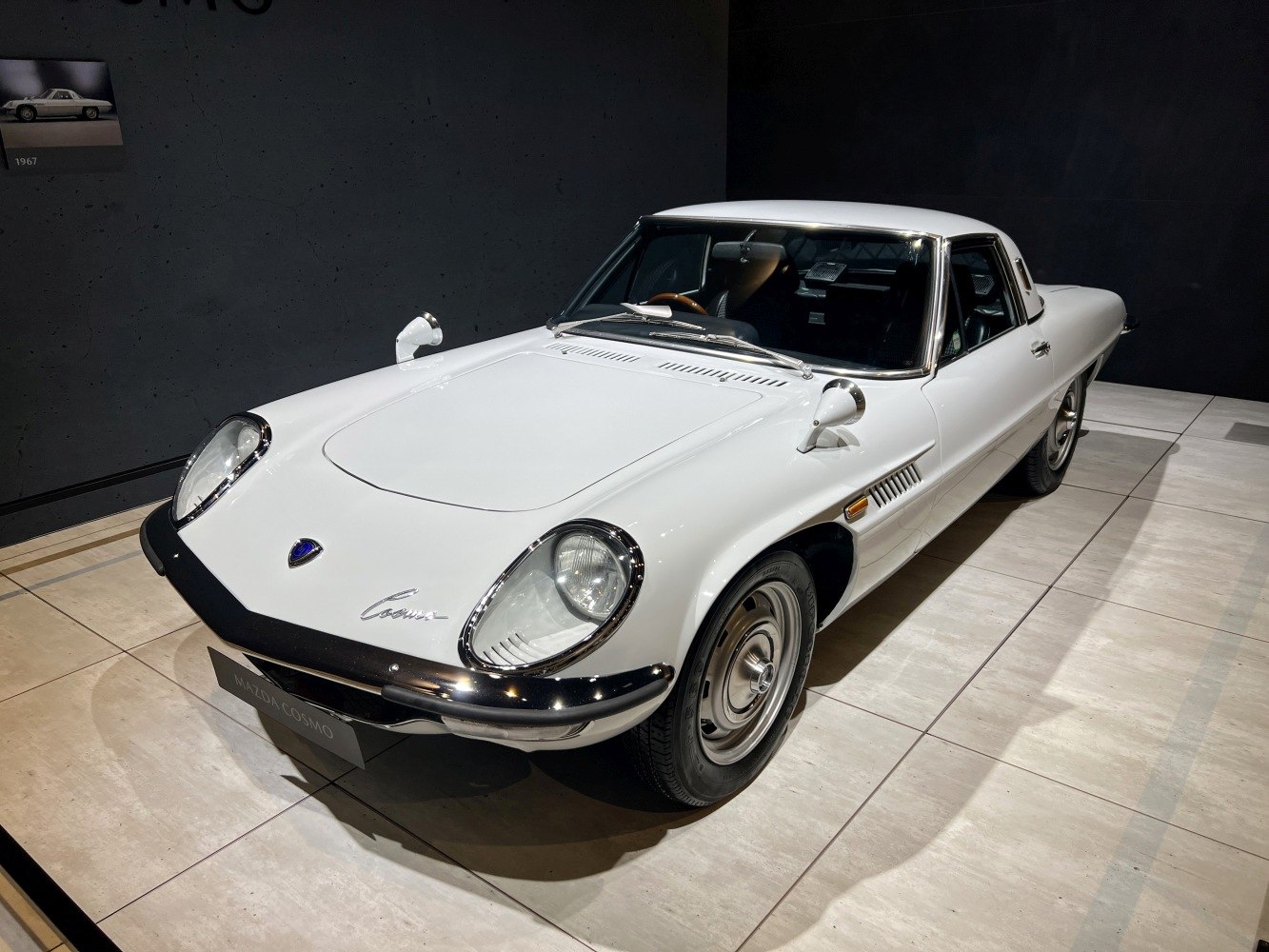 Oval headlights and sleek side profile of a 1960s vintage coupe