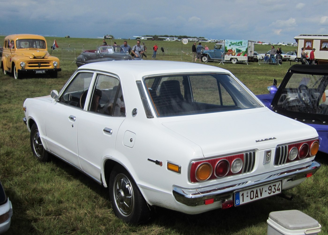 Rear view of classic sedan with round taillights and chrome bumper.
