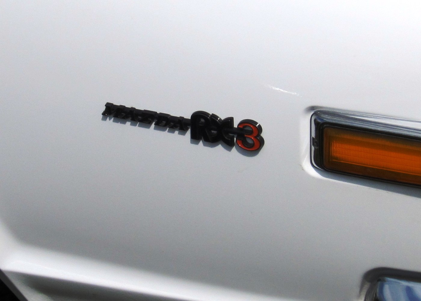 Mazda RX-3 badge and amber front side indicator light