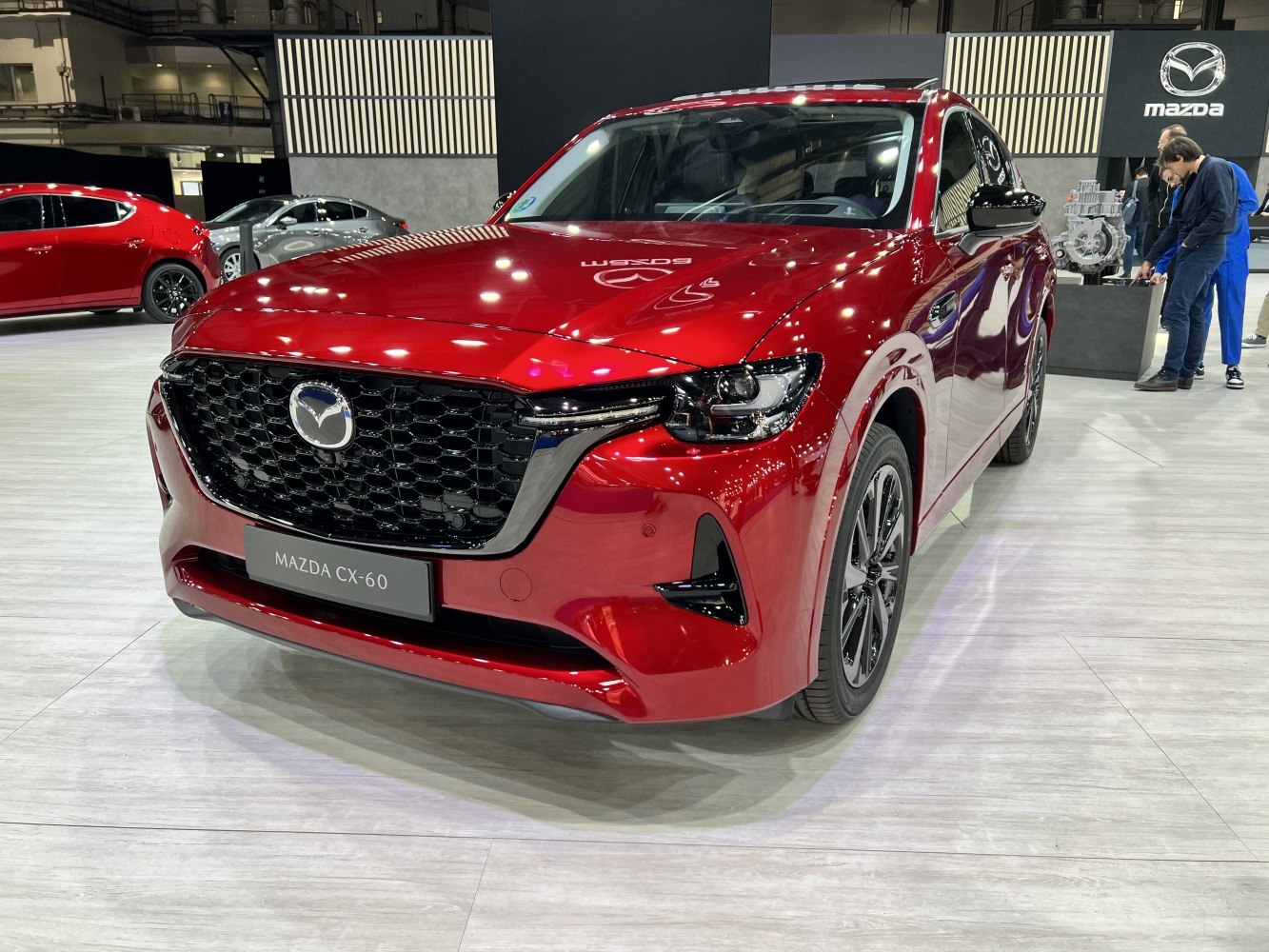 Front view showcasing grille and headlights of a red SUV.