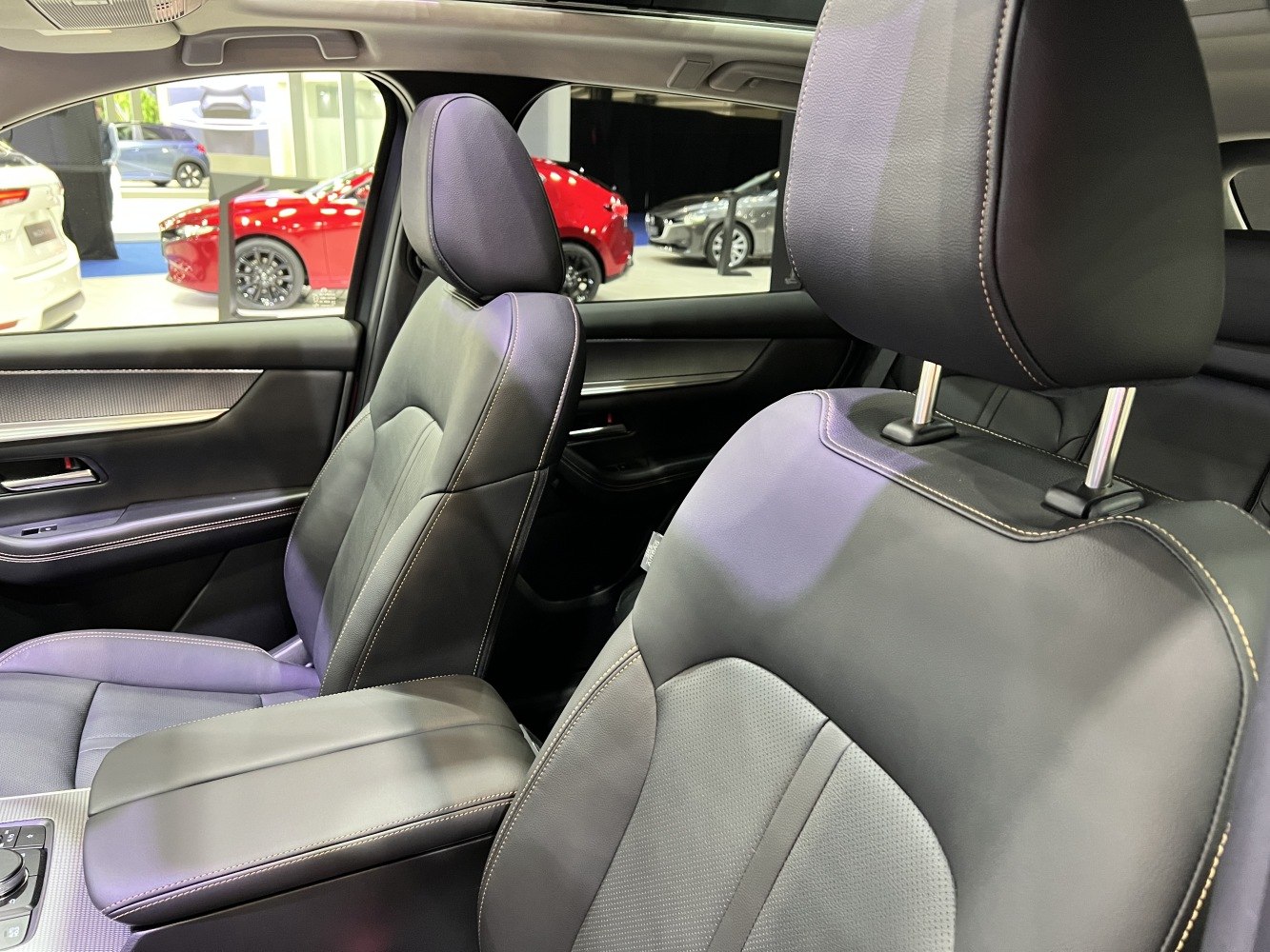 Leather front seats with detailed stitching and armrest.