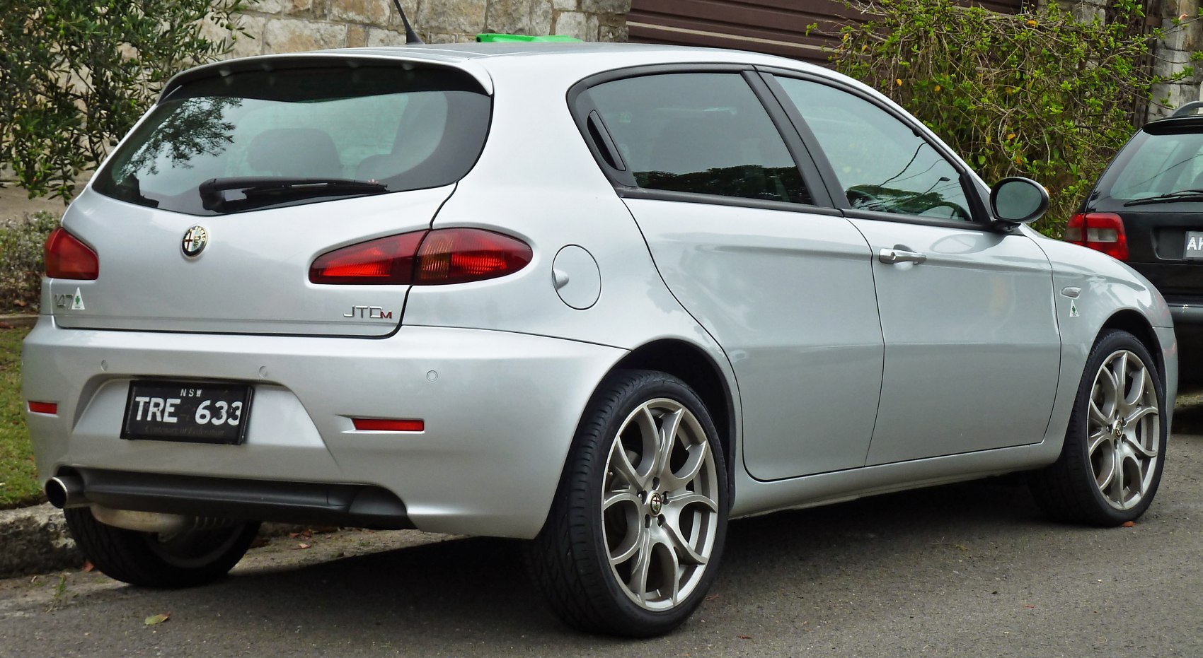Rear side view of silver 5-door hatchback with alloy wheels and distinctive taillights